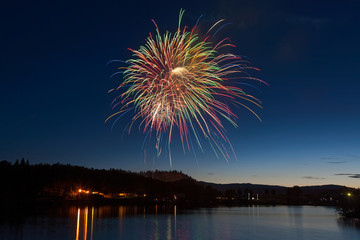 Celebration Fireworks Display Over a Mountain Lake at Dusk