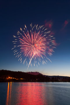Celebration Fireworks Display Over a Mountain Lake at Dusk