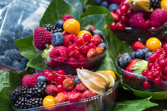 Berry background with fresh raspberries, blueberries, currants, strawberries, cherries.