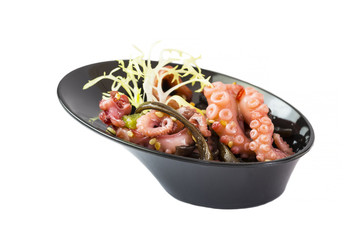 Mini canapes with seafood and vegetables and herbs and in plastic utensils isolated on white background.