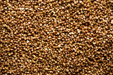 Roasted buckwheat texture. Food ingredient background. Top view, healthy lifestyle concept.