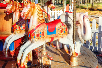 Outdoor colourful vintage flying horse carousel in the park