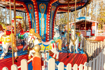 Obraz na płótnie Canvas Outdoor colourful vintage flying horse carousel in the park