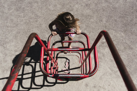 High angle view of girl climbing on metallic structure at park