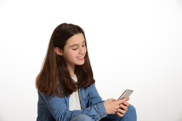Fototapeta premium Young teenager connected to the internet with his mobile.