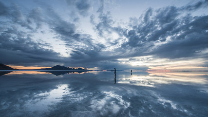 Symmetry view of lake against cloudy sky during sunset