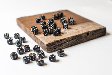 Black Dice on Wooden Background in Isolation