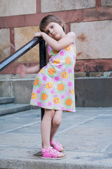 A girl in a dress poses