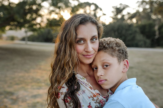 Portrait of mother and son standing at park