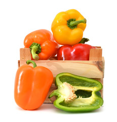 colorful mix of paprika's(capsicum) in a wooden box on a white background