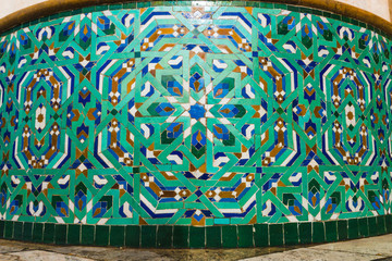 ow angle view of moroccan traditional water tap decorated with colorful shapes of mosaic