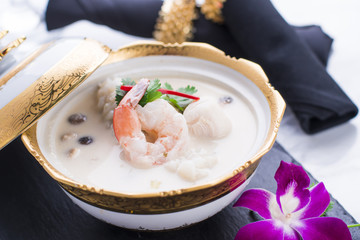Tom Kha or Thai coconut milk soup with seafood