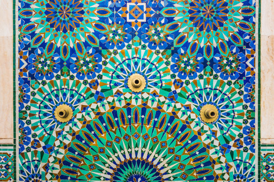 full frame shot of moroccan traditional water tap decorated with colorful shapes of mosaic in Hassan II mosque - Casablanca - Morocco