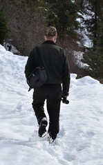 Fototapeta na wymiar Man hiking through snow