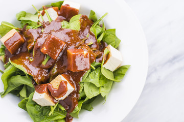 Steam tofy and spinach topped with peanut sauce