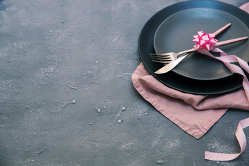 Shabby chic table setting. rustic style on stone table: grey plates, vintage silverware, linen napkin
