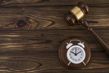 The concept of a clock and a hammer by the judge. Idea: the time of the trial, the Verdict.