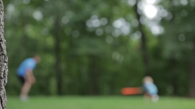Defocussed shot of father and son playing baseball at yard
