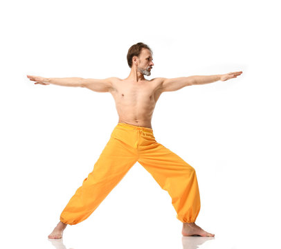 Old Man Practicing Yoga Doing Sport Stretching Exercises In Yellow Pants 