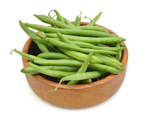 green beans in wooden bowl on a white background