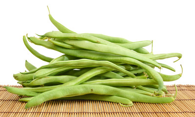 small and slender green beans (haricot vert) on a bamboo mat