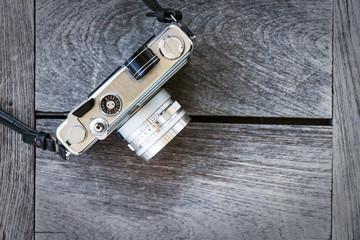 Retro vintage classic camera film on wood background