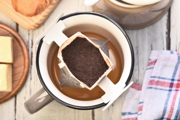 Instant freshly brewed cup of coffee on a wooden table