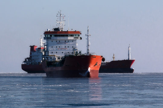 two tankers anchored in a frozen sea awaiting loading operations