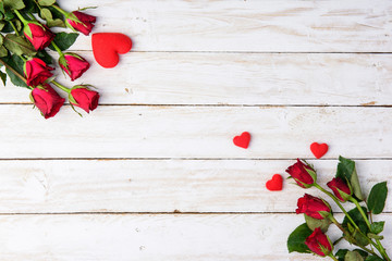 Red roses and hearts on old white wood table/Valentines day background