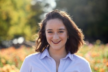 Portrait of a young woman smiling outdoors in the spring