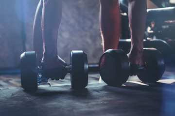 close up sport man holding dumbbells prepare to work out in gym