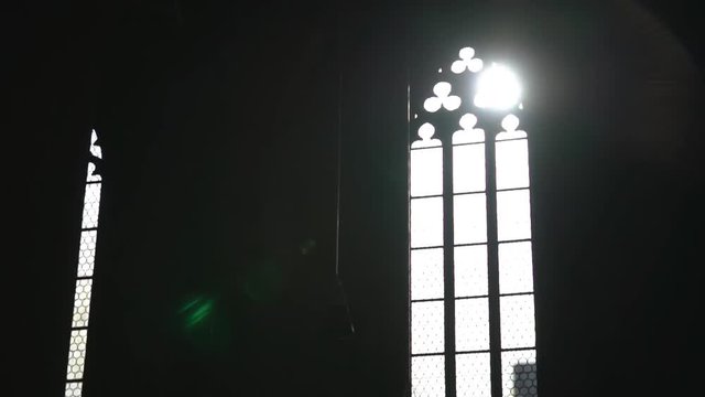 Tilt down shot of sunlight passing through window at church