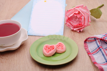 Strew berry heart cookies  on green plate 