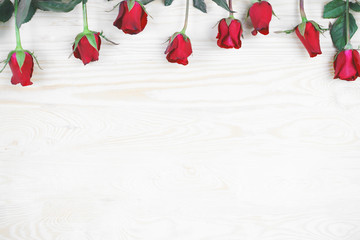 Red rose on wood background with copy space.