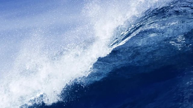 Slow motion handheld shot of huge wave splashing in sea
