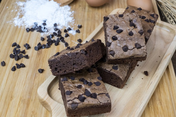 Chocolate brownie portions on wooden plate,Sliced of homemade chocolate brownie on wooden plate