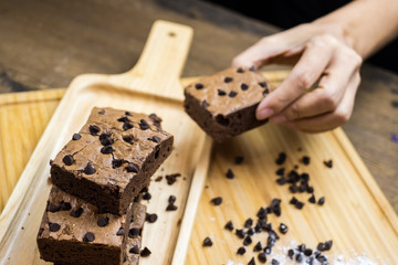 Chocolate brownie portions on wooden plate,Sliced of homemade chocolate brownie on wooden plate