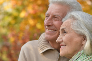 senior couple hugging   in the park 