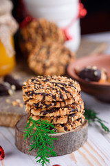 Sweet biscuits with peanuts in a plate with honey and milk on a table