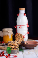 Sweet biscuits with peanuts in a plate with honey and milk on a table