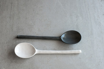 white and gray spoon ceramic on a gray background
