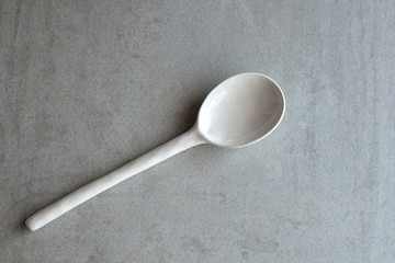 white and gray spoon ceramic on a gray background