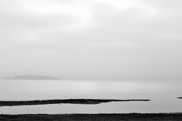 Minimalistic view of Trasimeno lake shore at dawn with soft tones