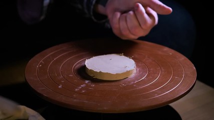 Potter special tools handles clay. Master crock. The creative process in the studio. Twisted potter's wheel. Man creates a work of art. The ability to create beauty. Master kneads the clay