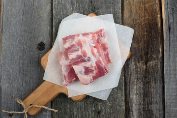 fresh pork ribs on a cutting Board, wooden background