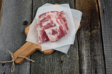 fresh pork ribs on a cutting Board, wooden background