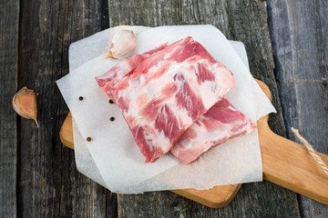 fresh pork ribs on a cutting Board, wooden background