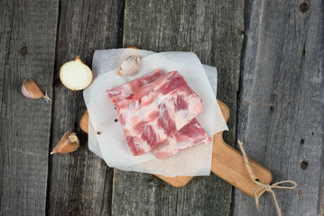 fresh pork ribs on a cutting Board, wooden background