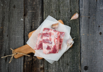 fresh pork ribs on a cutting Board, wooden background