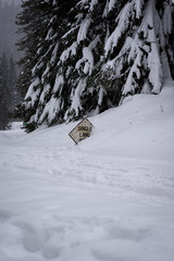 Road sign buried in deep snow